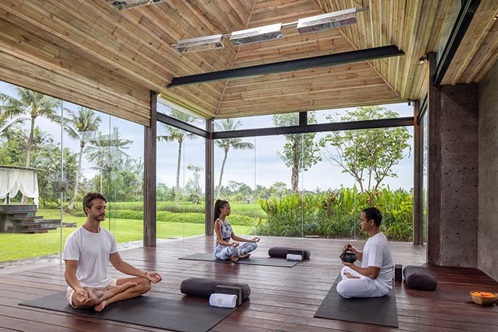 Small guided meditation session in an open-air Bali yoga studio