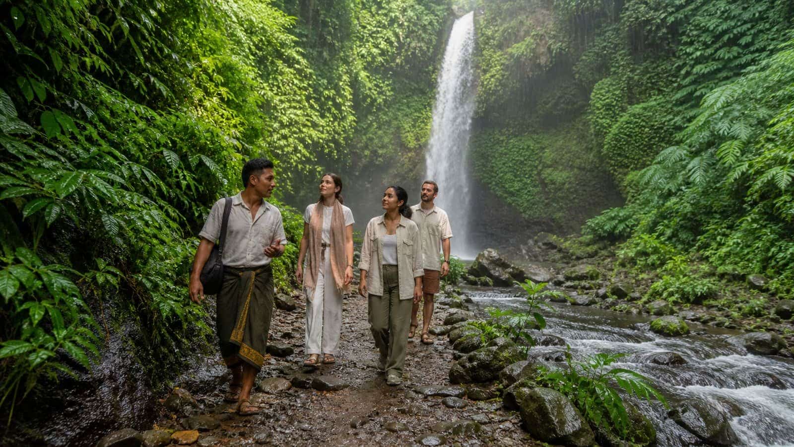 Guests on a sacred waterfall trek during nature immersion at a North Bali longevity retreat